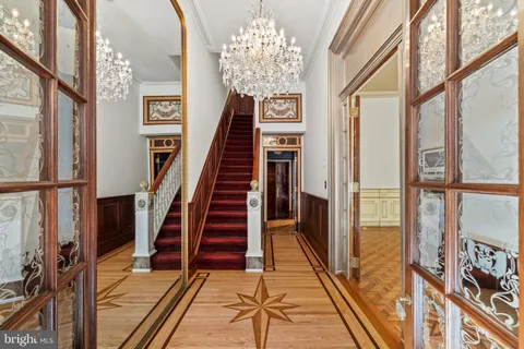 a view of an entryway with wooden floor and a front door