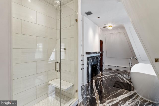 a large kitchen with stainless steel appliances a stove and a refrigerator