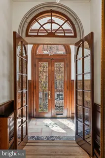 a view of a livingroom with a fireplace and chandelier
