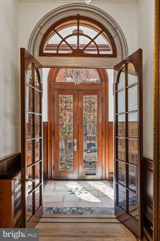 a view of a livingroom with a fireplace and chandelier