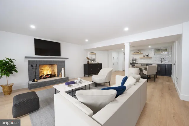 a living room with furniture and a fireplace