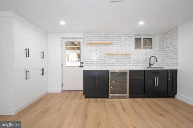 a spacious bathroom with a granite countertop sink and a mirror