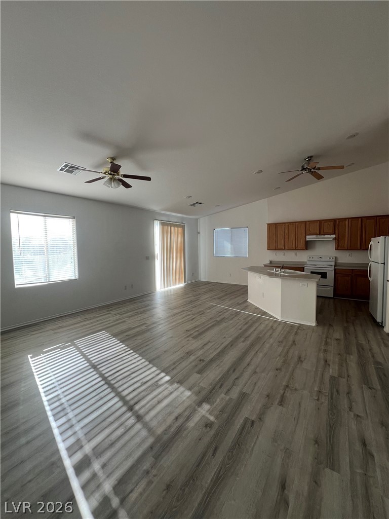 6472 Centennial Road Pahrump, NV 89048 - Photo 30 of 33 An open concept living area features resilient plank flooring and a functional kitchen island.