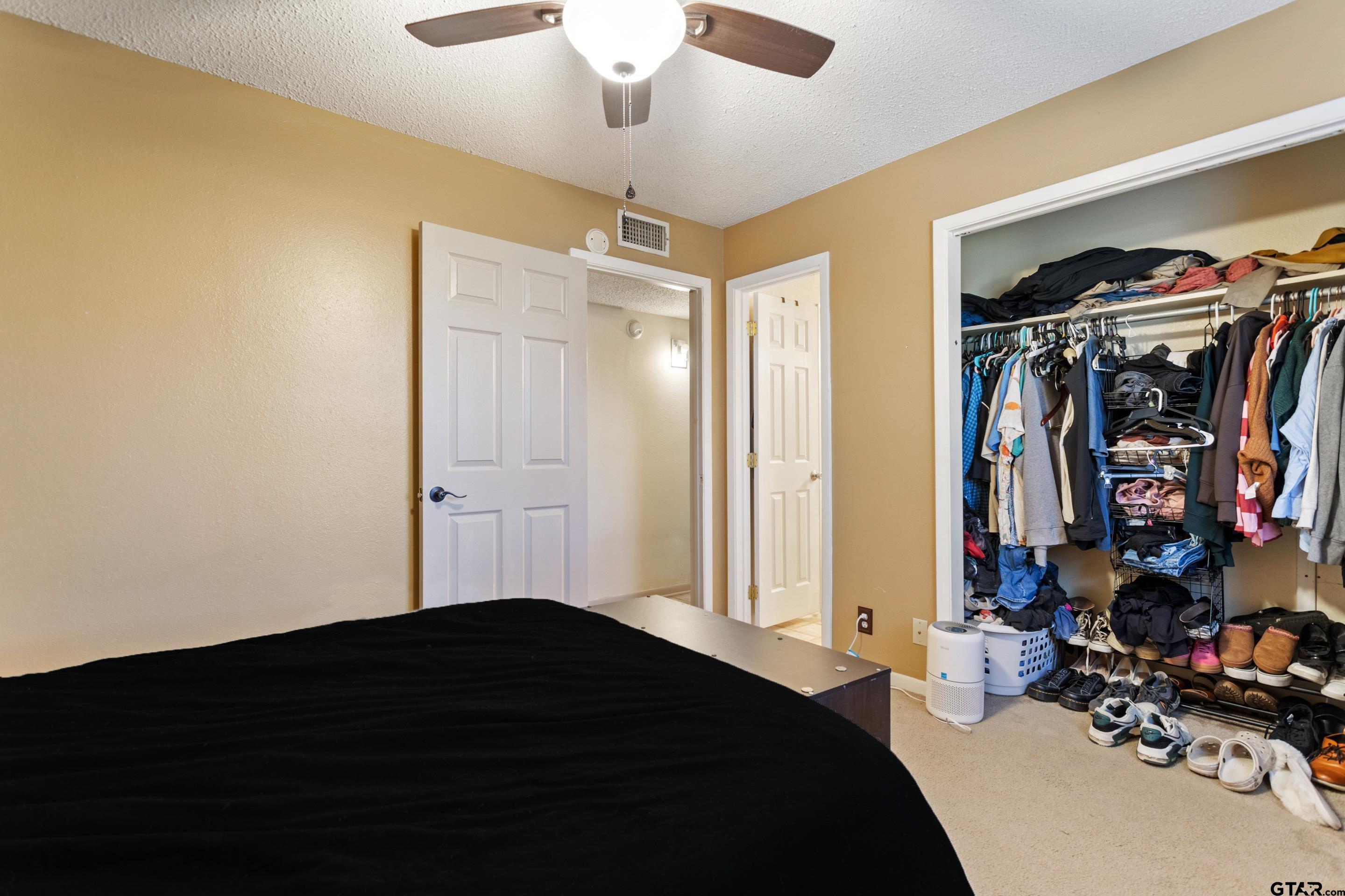 1106 Brad Circle Lindale, TX 75771 - Photo 16 of 27 a bedroom with a bed and a walk in closet