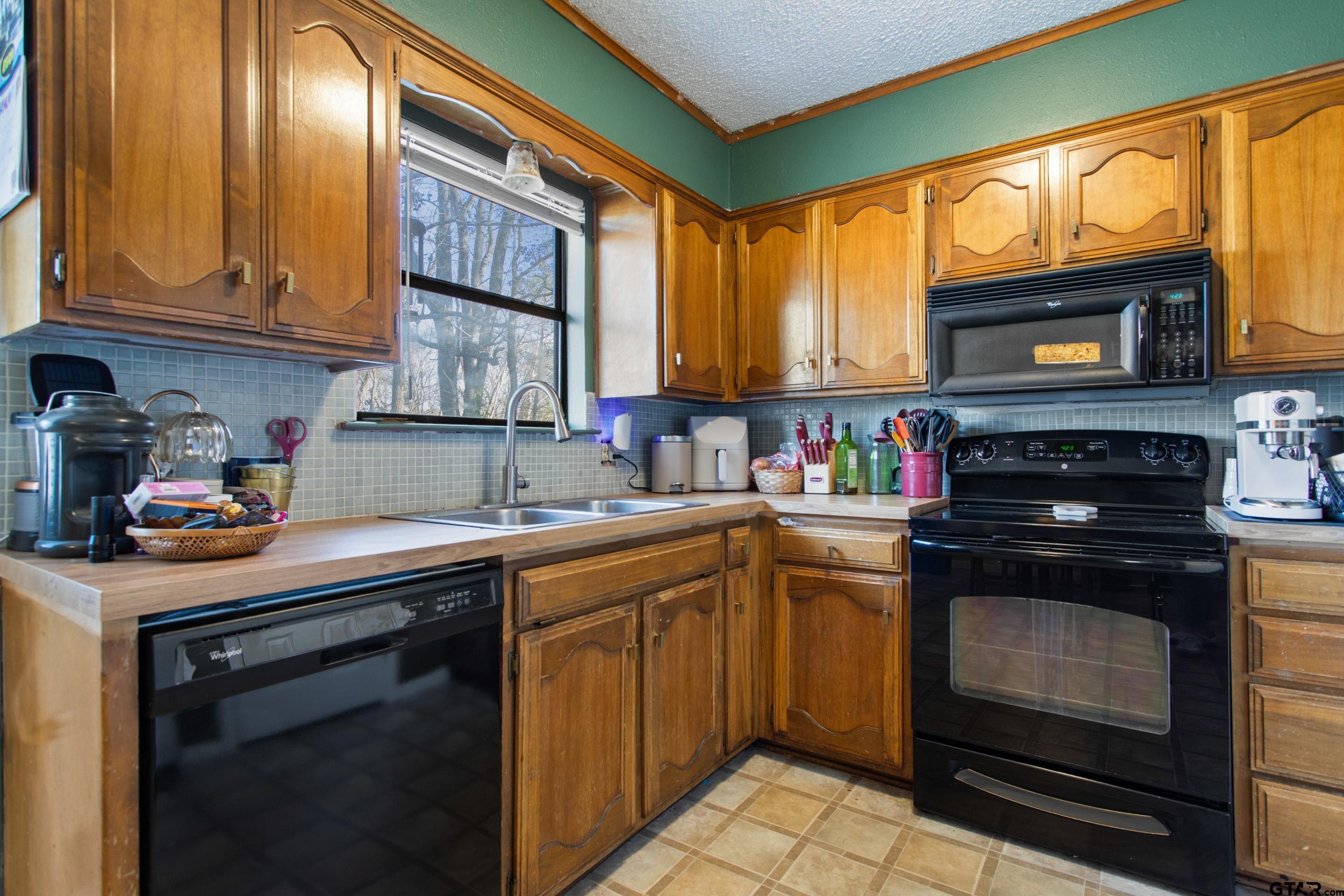 1106 Brad Circle Lindale, TX 75771 - Photo 2 of 27 a kitchen with a sink stove and microwave