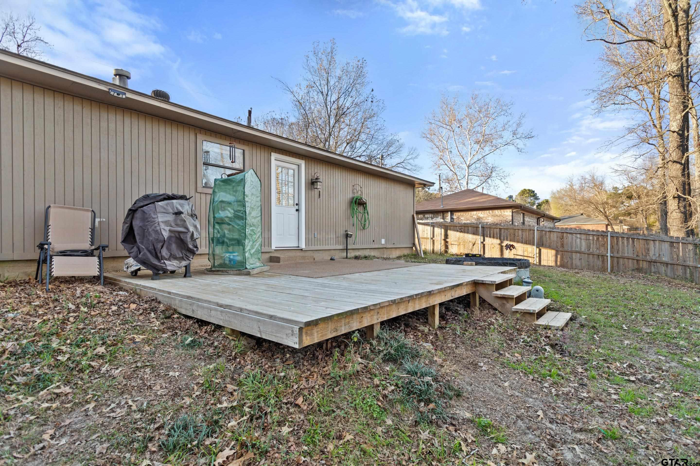 1106 Brad Circle Lindale, TX 75771 - Photo 24 of 27 a wooden bench sitting in front of a house