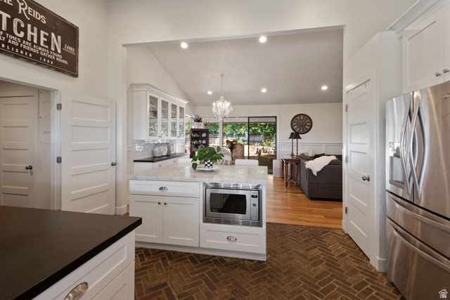 1900 North 100 East Provo, UT 84604 - Photo 14 of 49 Kitchen featuring brick-pattern flooring, white cabinetry, a built-in microwave, and stainless steel appliances