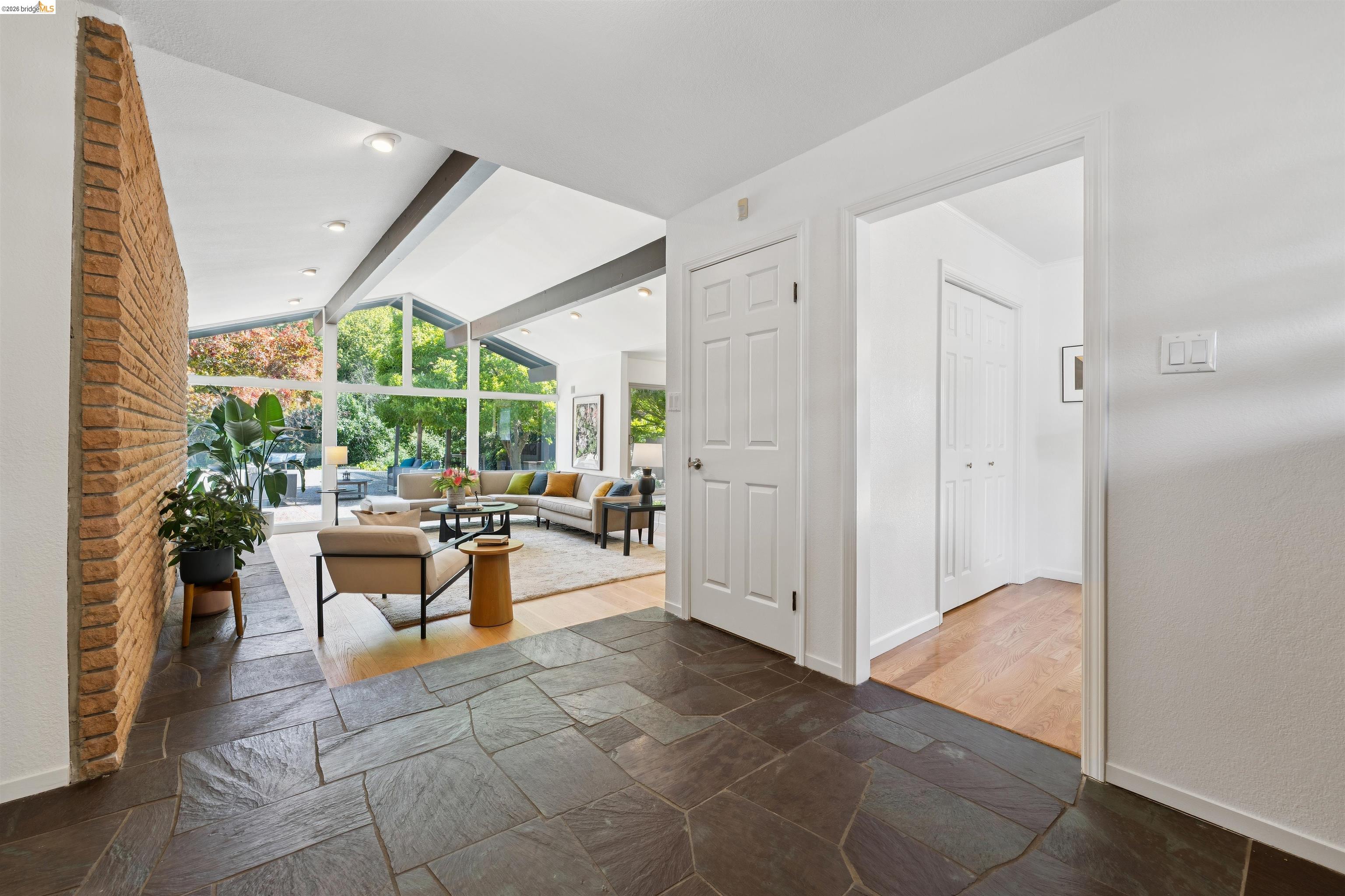 7 Jo Lin Court El Sobrante, CA 94803 - Photo 23 of 99 Foyer featuring natural stone tile flooring and a brick accent wall