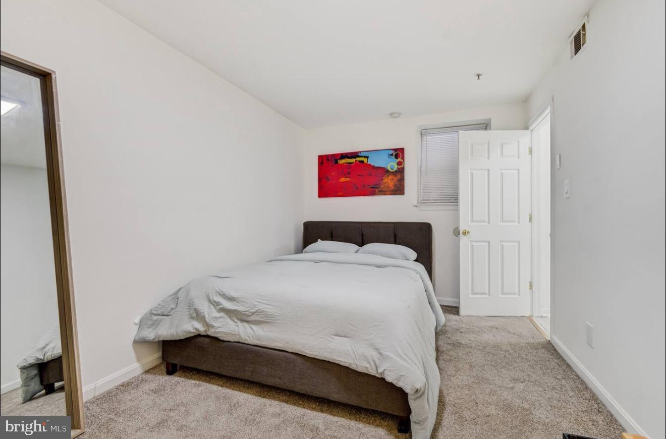 623 5th Street Northeast, Unit 6 Washington, DC 20002 - Photo 11 of 15 a bedroom with a bed and cabinets
