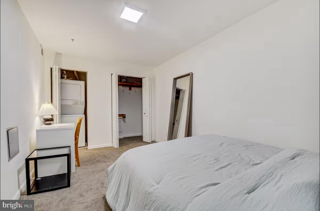 623 5th Street Northeast, Unit 6 Washington, DC 20002 - Photo 12 of 15 a spacious bedroom with a bed and a chair