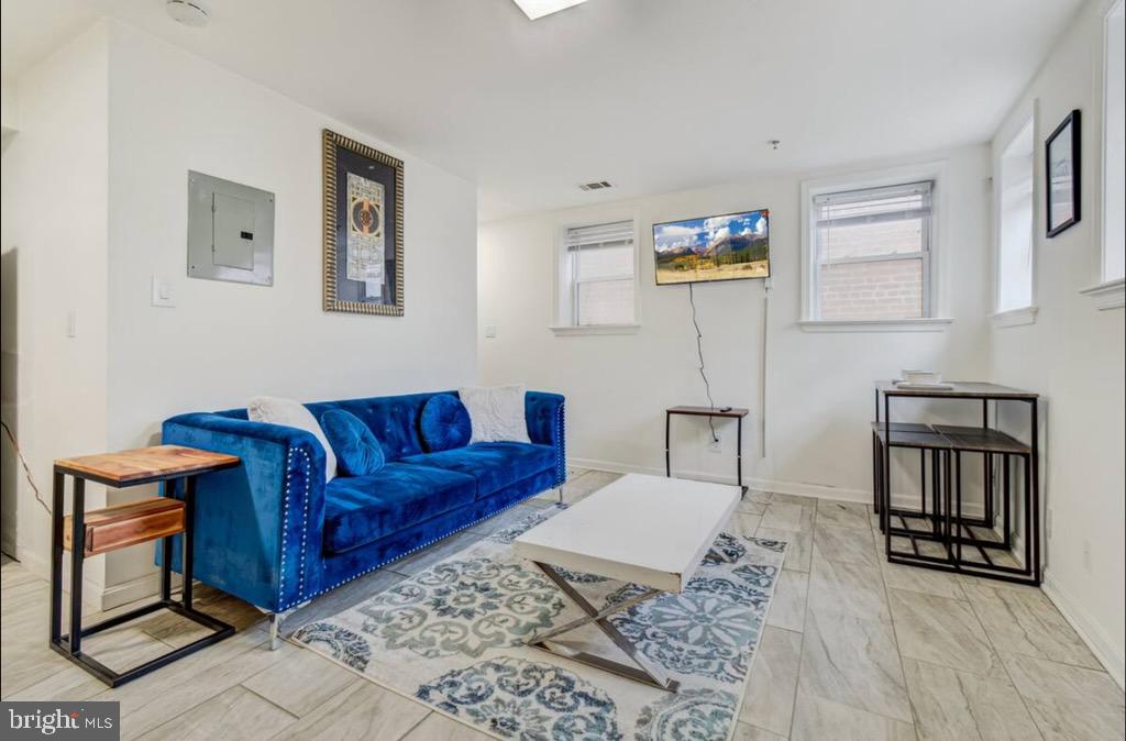 623 5th Street Northeast, Unit 6 Washington, DC 20002 - Photo 6 of 15 a living room with couch cabinets and a window