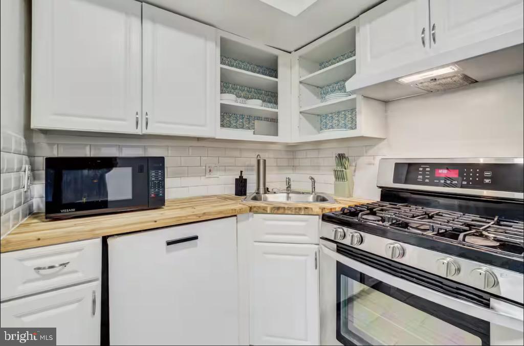 623 5th Street Northeast, Unit 6 Washington, DC 20002 - Photo 8 of 15 a kitchen with stainless steel appliances granite countertop a stove and a microwave