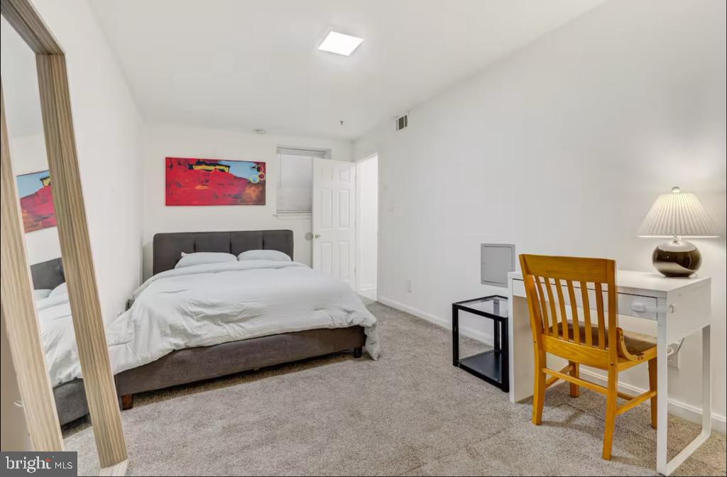 623 5th Street Northeast, Unit 6 Washington, DC 20002 - Photo 9 of 15 a bedroom with a bed and a chair