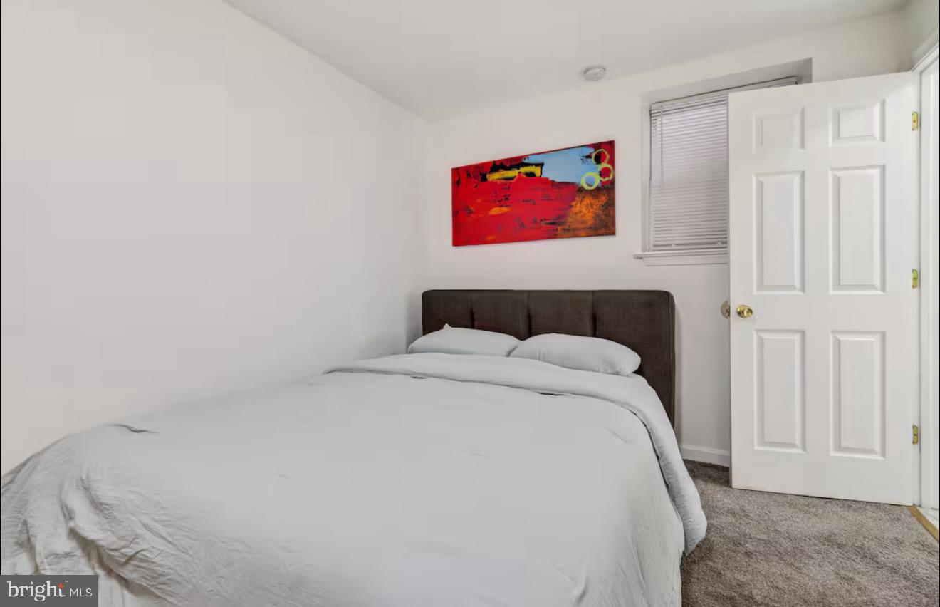 623 5th Street Northeast, Unit 6 Washington, DC 20002 - Photo 10 of 15 a bedroom with a bed and wooden floor