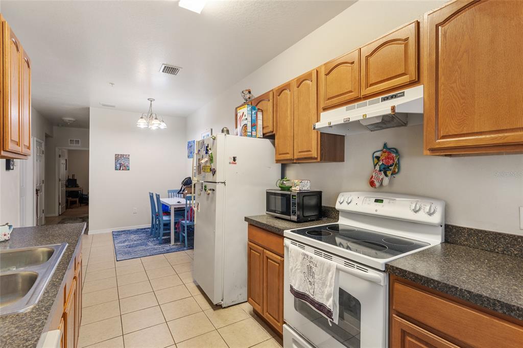 1573 Northwest 29 Road, Unit 3 Gainesville, FL 32605 - Photo 12 of 20 a kitchen that has a sink and a stove