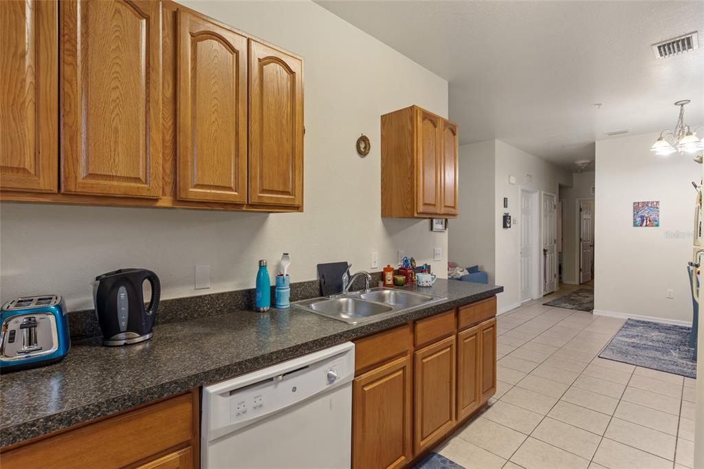 1573 Northwest 29 Road, Unit 3 Gainesville, FL 32605 - Photo 13 of 20 a kitchen with stainless steel appliances granite countertop a sink and cabinets