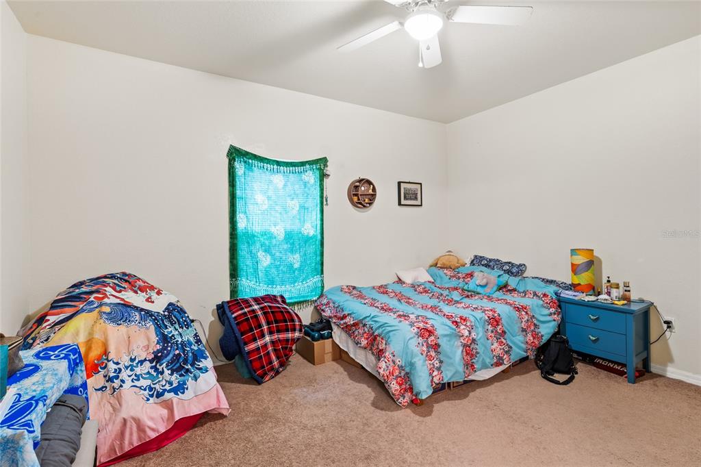 1573 Northwest 29 Road, Unit 3 Gainesville, FL 32605 - Photo 14 of 20 a bedroom with bed and window