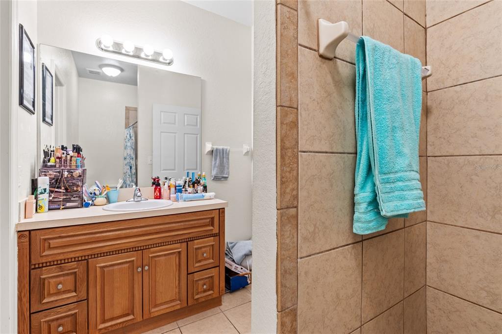 1573 Northwest 29 Road, Unit 3 Gainesville, FL 32605 - Photo 17 of 20 a bathroom with a sink and a mirror