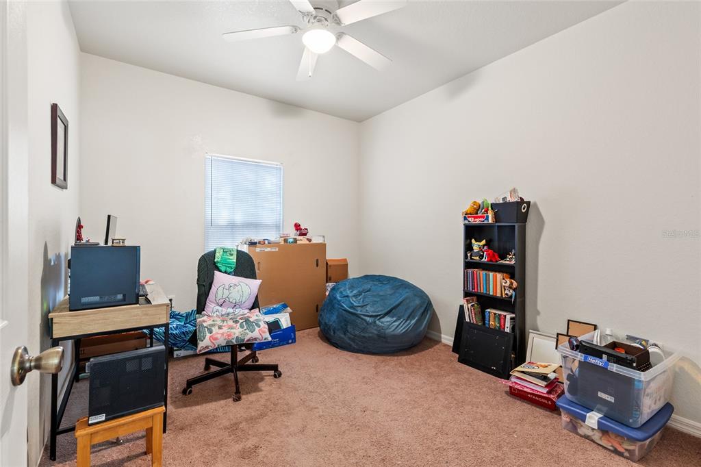1573 Northwest 29 Road, Unit 3 Gainesville, FL 32605 - Photo 18 of 20 a living room with furniture and a window
