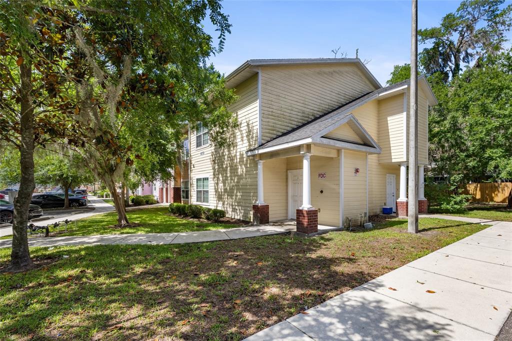 1573 Northwest 29 Road, Unit 3 Gainesville, FL 32605 - Photo 2 of 20 a front view of a house with a yard
