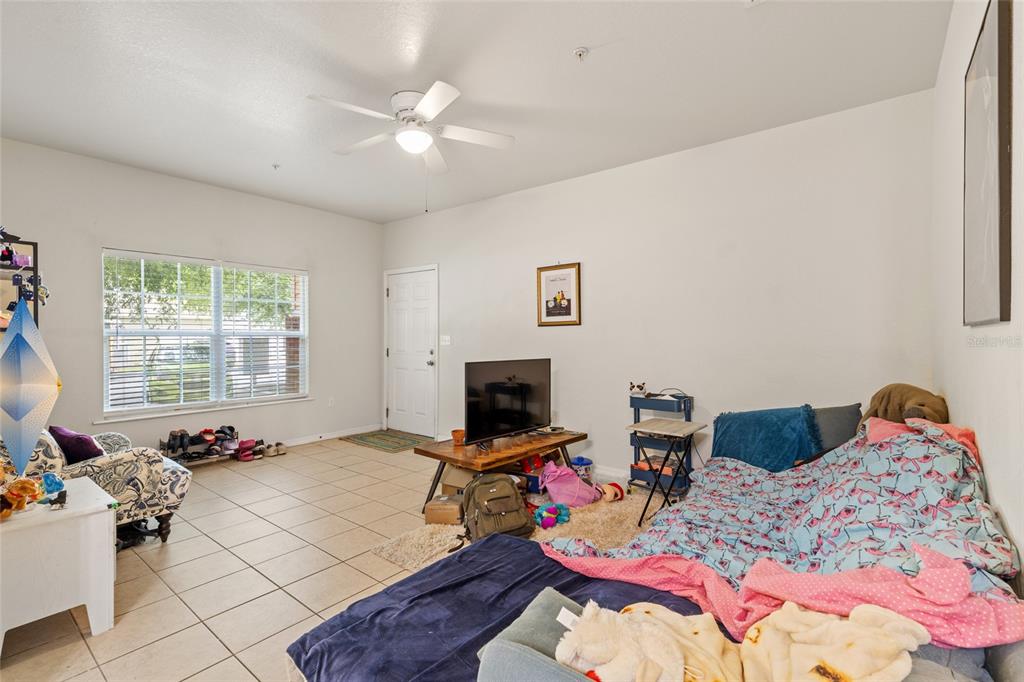 1573 Northwest 29 Road, Unit 3 Gainesville, FL 32605 - Photo 7 of 20 a bedroom with bed and a window