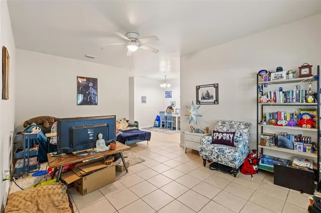 a living room with furniture and a dining table