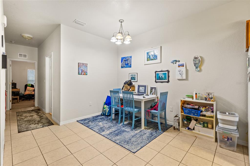 1573 Northwest 29 Road, Unit 3 Gainesville, FL 32605 - Photo 9 of 20 a living room with furniture and a dining table