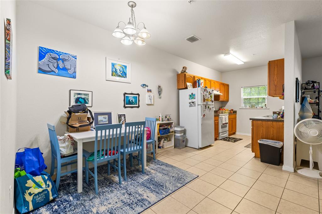 1573 Northwest 29 Road, Unit 3 Gainesville, FL 32605 - Photo 10 of 20 a view of a dining room with furniture window and outdoor view