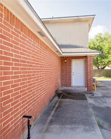 a view of backyard with blue wall and a large window