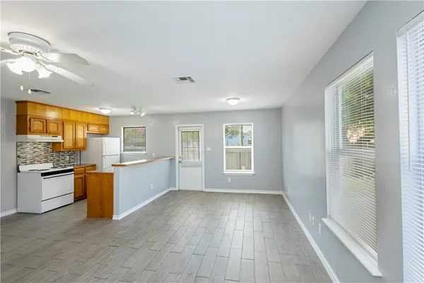 a view of a kitchen with a sink dishwasher and fireplace