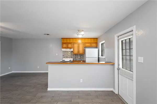 a view of a room with kitchen island and natural light