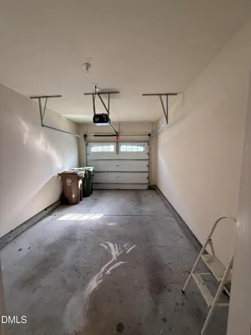 a view of room and utility room with racks on the wall