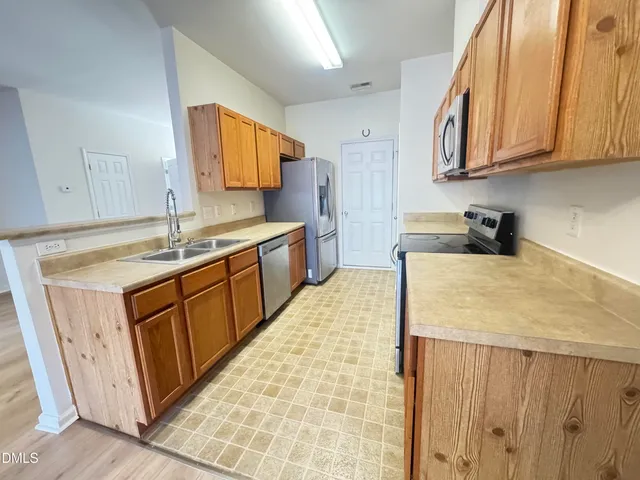 a kitchen with stainless steel appliances granite countertop a sink stove and cabinets