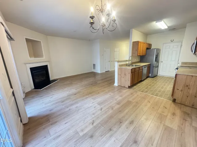 a view of a kitchen with wooden floor and electronic appliances