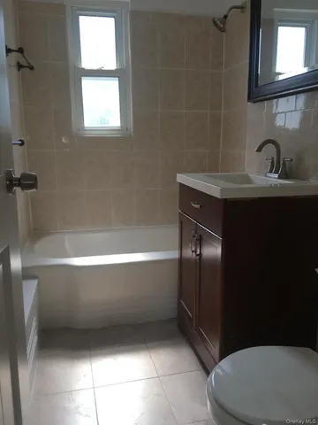 a bathroom with a sink a toilet and bathtub
