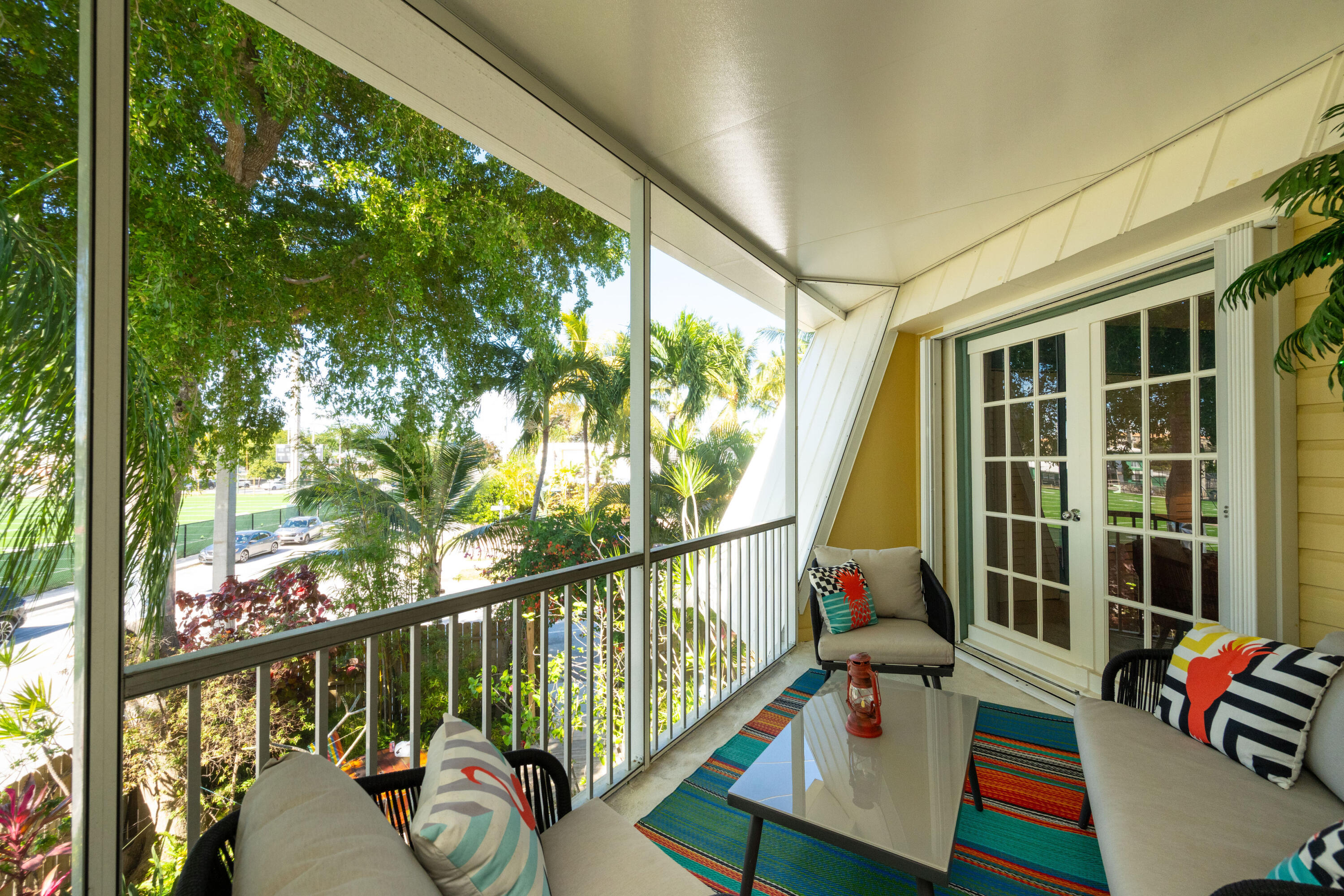 3200 Eagle Avenue Key West, FL 33040 - Photo 3 of 25 a balcony with wooden floor and outdoor seating