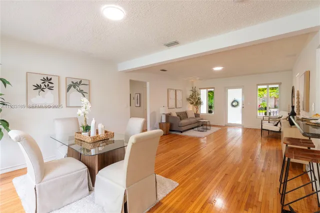 a living room with fireplace furniture and a wooden floor