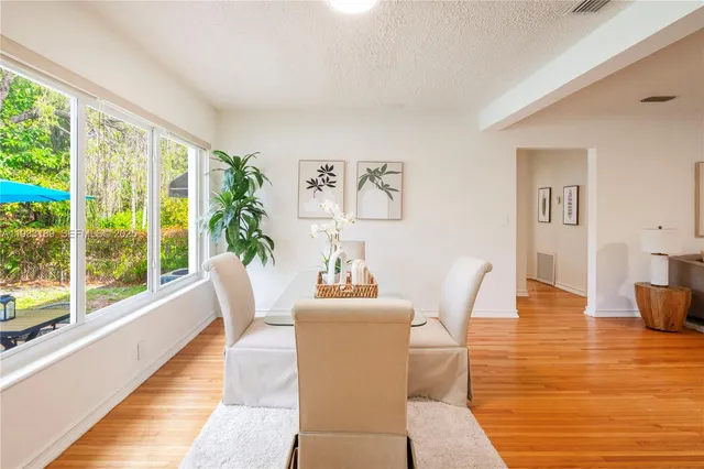 a dining room with furniture and wooden floor