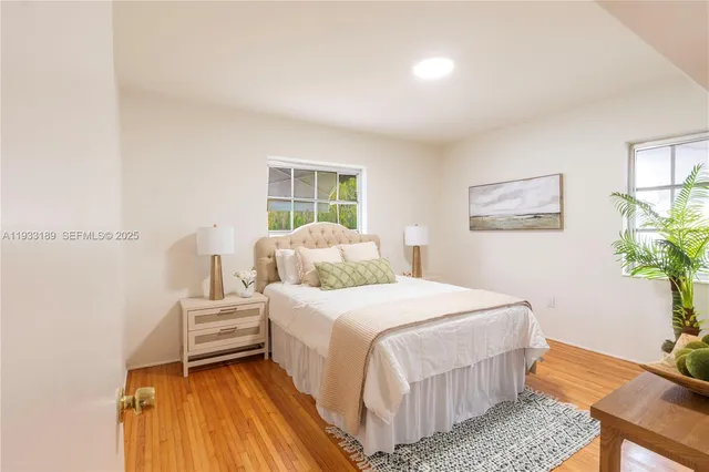 a bedroom with a bed and a potted plant