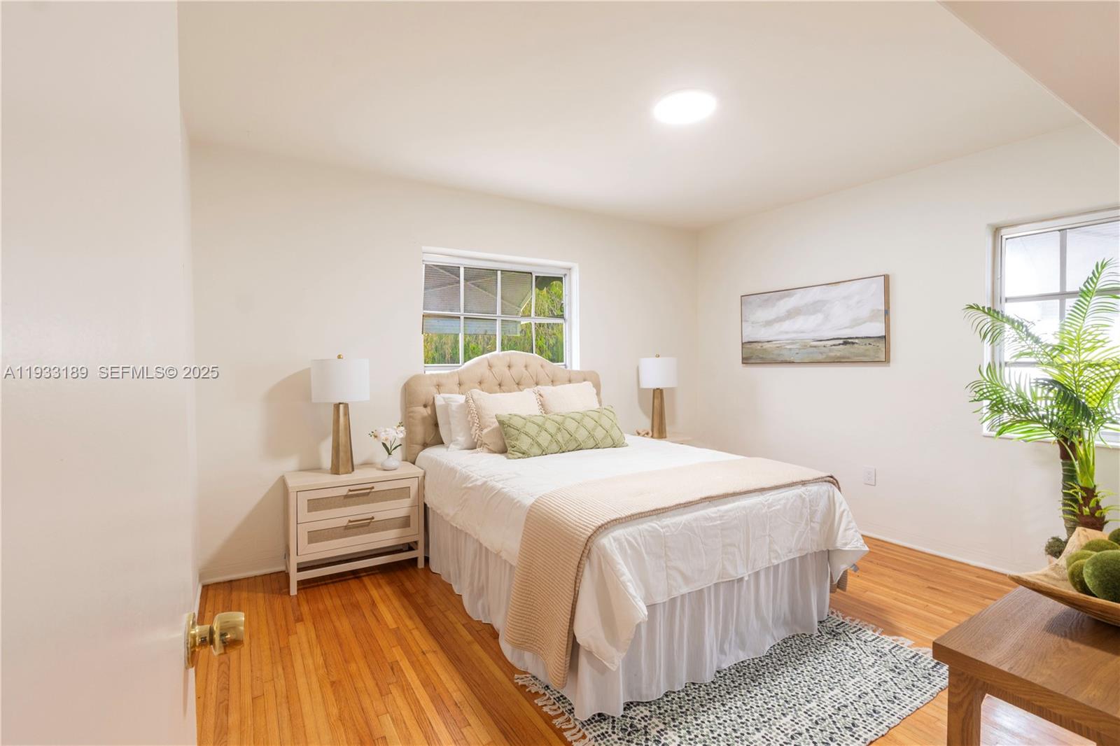 339 Falcon Avenue Miami Springs, FL 33166 - Photo 14 of 29 a bedroom with a bed and a potted plant