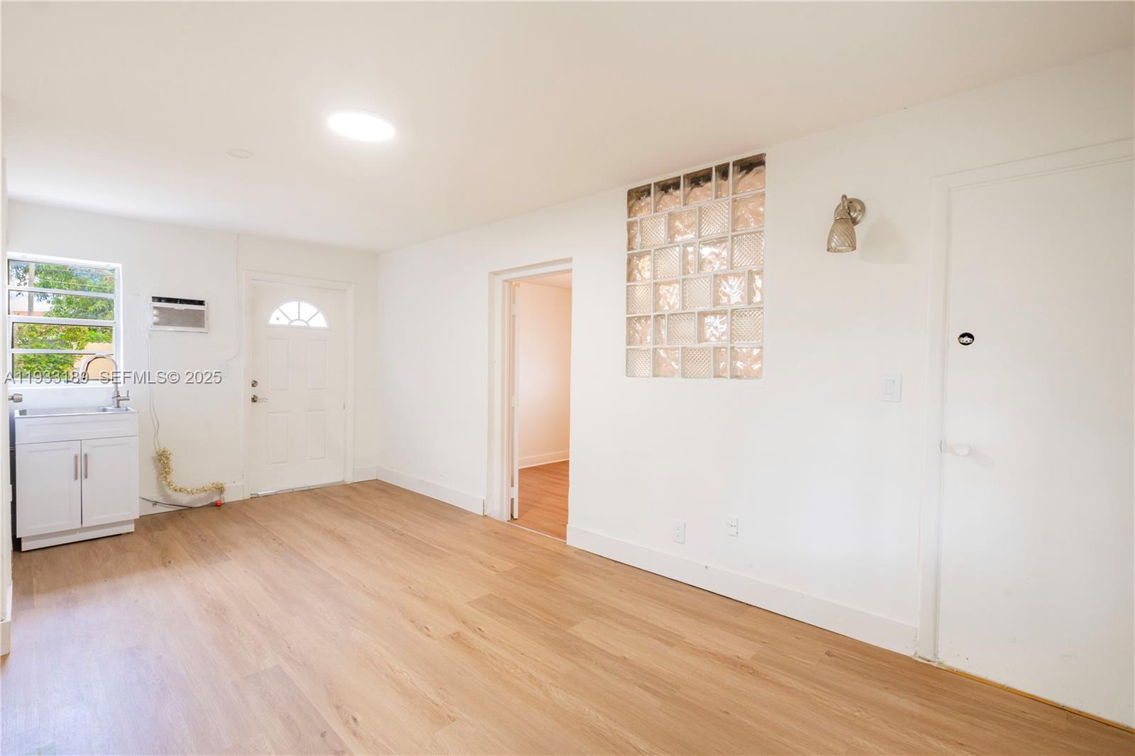 339 Falcon Avenue Miami Springs, FL 33166 - Photo 25 of 29 an empty room with windows and cabinet