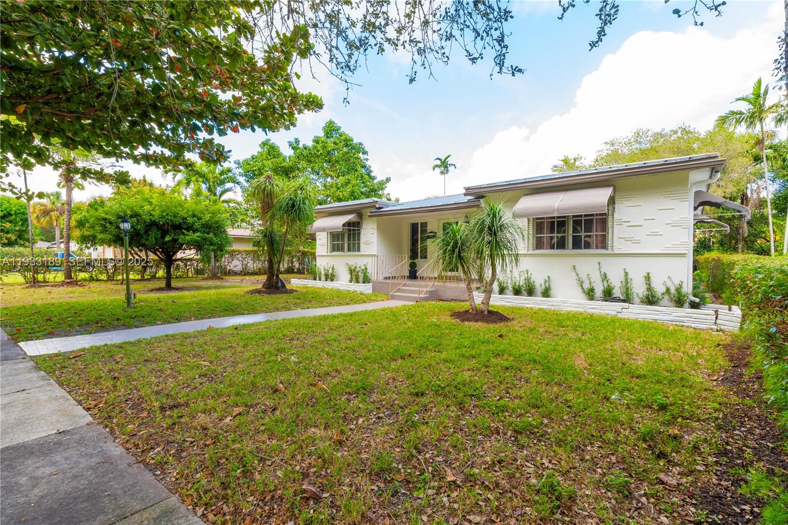 339 Falcon Avenue Miami Springs, FL 33166 - Photo 27 of 29 a front view of house with yard and green space