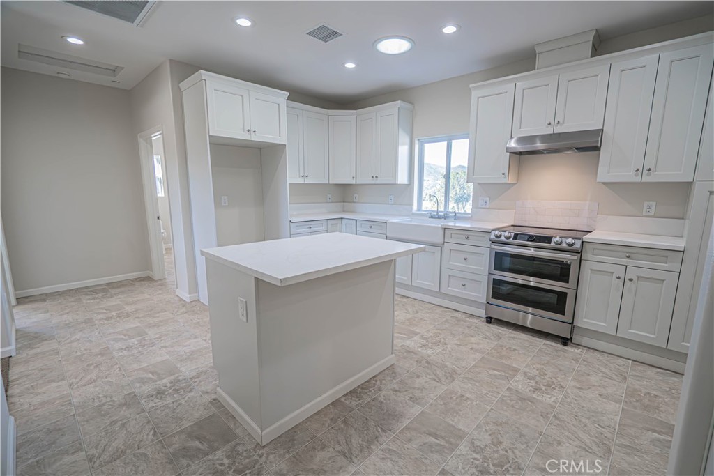 10540 Darling Road Agua Dulce, CA 91390 - Photo 20 of 56 a kitchen that has a sink and a stove in it