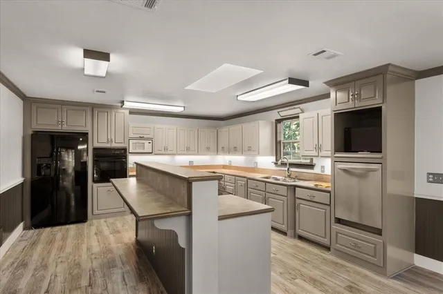 a kitchen with cabinets and stainless steel appliances