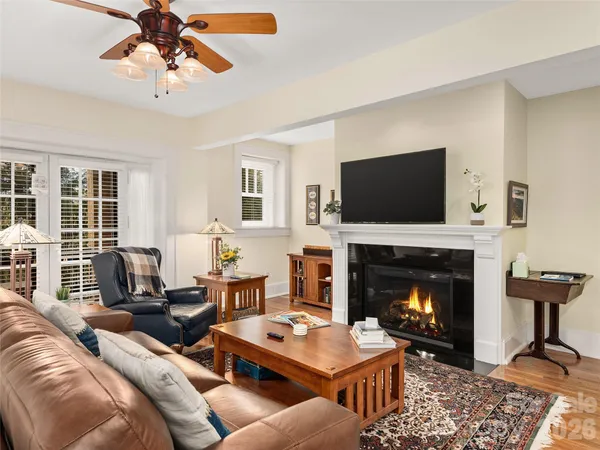 a living room with furniture a flat screen tv and a fireplace