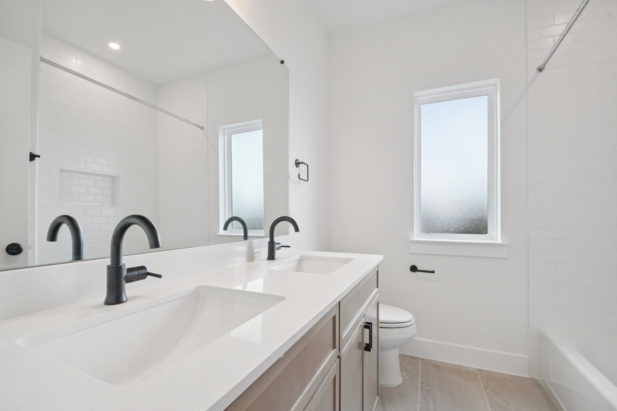 1660 Cardinal Lane Round Rock, TX 78681 - Photo 30 of 35 a bathroom with a sink a toilet and a window