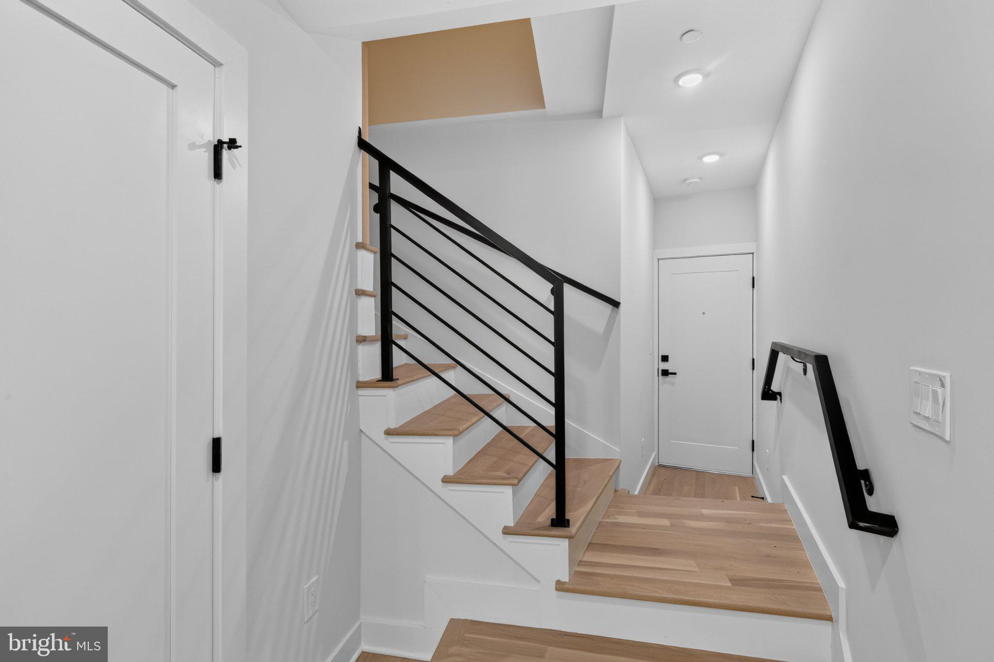 1650 Columbia Road Northwest, Unit 402 Washington, DC 20009 - Photo 7 of 19 Modern entryway with sleek staircase.