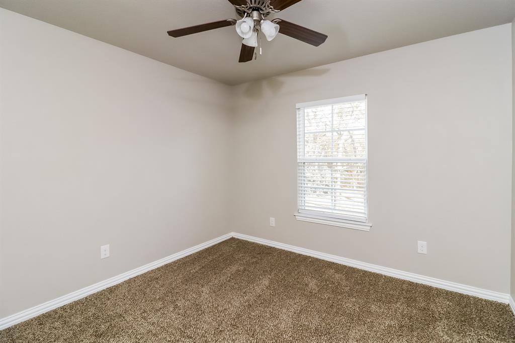206 Perry Avenue Waxahachie, TX 75165 - Photo 11 of 15 an empty room with a window and a fan