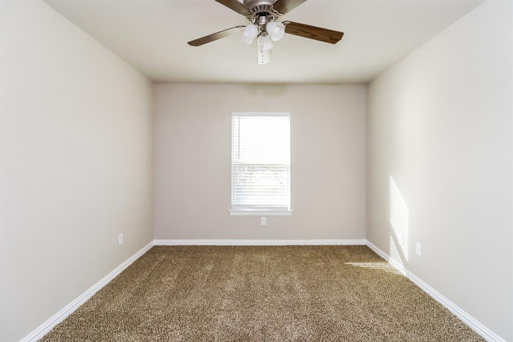 206 Perry Avenue Waxahachie, TX 75165 - Photo 12 of 15 an empty room with a window and a fan
