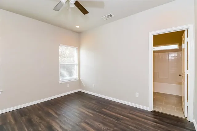 an empty room with a empty space and windows